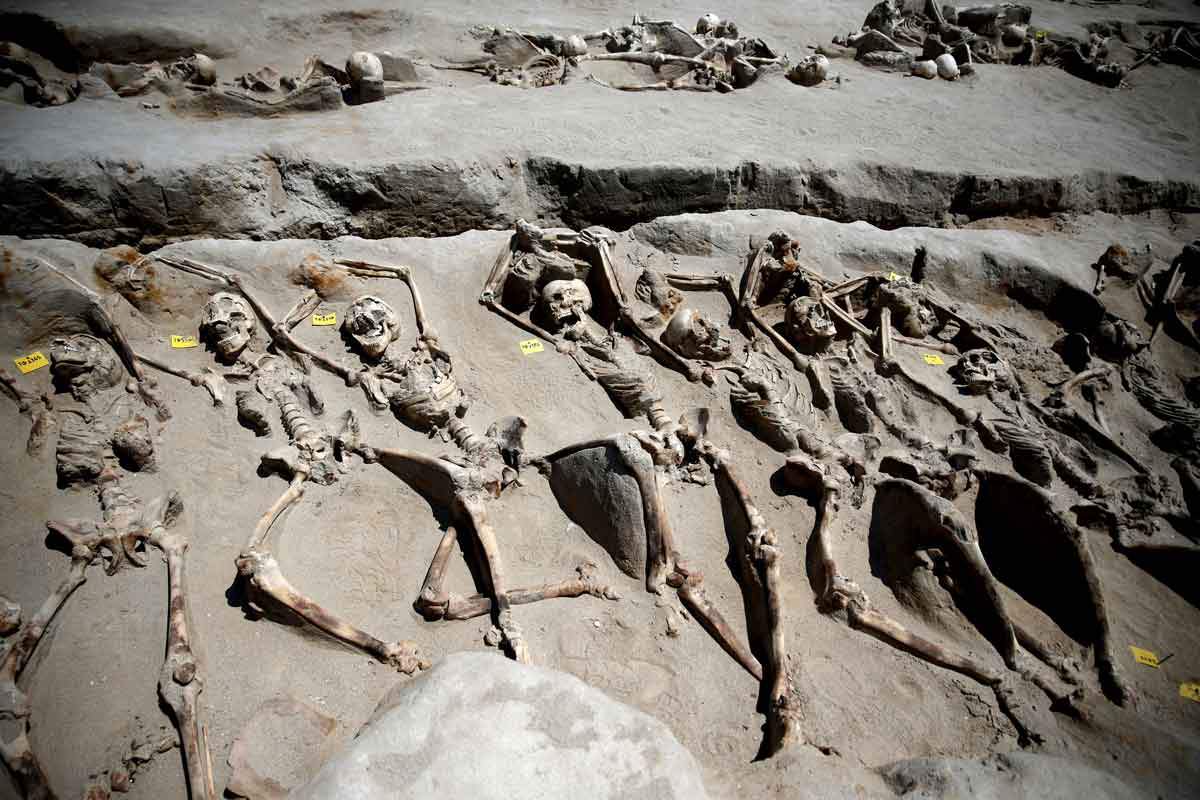 shackled skeletons in mass grave