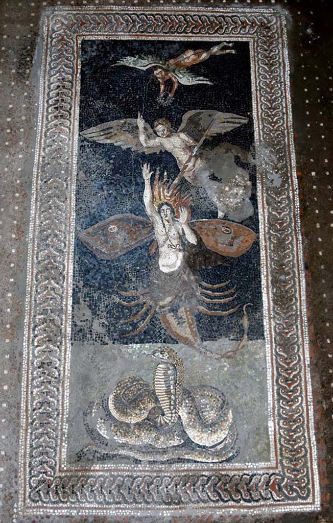 V.2.15 Pompeii. October 2018. Room A13 on south side of atrium. An exceptional mosaic floor with a mythological or astrological theme was found. According to the Massimo Osanna this may depict the catasterism of Orion. The snake represents the Earth. The goddess Gaia had been angered by the giant and hunter Orion announcing that he will hunt every animal on earth. She sent a scorpion to kill him. The scorpion rose from the Earth and fatally stung Orion. Zeus turns both of them into stars in the heavens. The wings on Orion represent his transformation. A pagan winged creature carries a torch to set Orion aflame, whilst pointing to the heavens and a second creature offers Orion a crown. According to Greek mythology Orion is the brightest constellation. Photograph © Parco Archeologico di Pompei. 