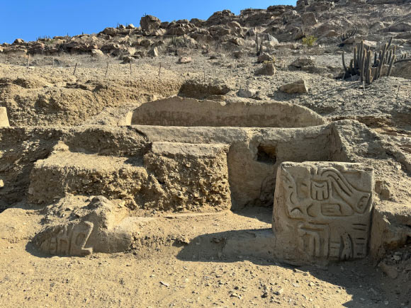 The newly-discovered archaeological site, including carving of a mythological bird creature, at La Otra Banda, Cerro Las Animas, Peru. Image credit: Ucupe Cultural Landscape Archaeological Project.