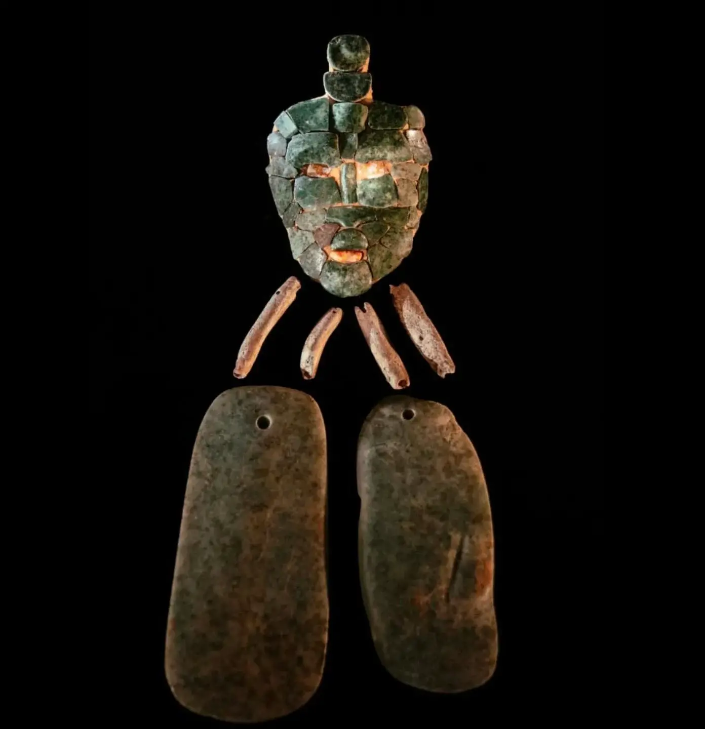 The burial site was a very small space. Along with pieces of bone, the team also found chunks of jade that would put together to create this extraordinary mask. 